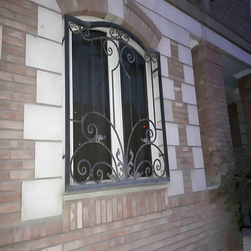 گارد پنجره مشکی مجاور باغچه خیس حیاط